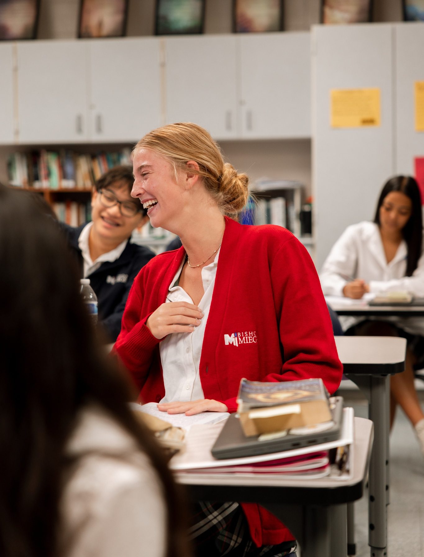 Three students on Junior Retreat stand arm-in-arm as they grow in their faith.